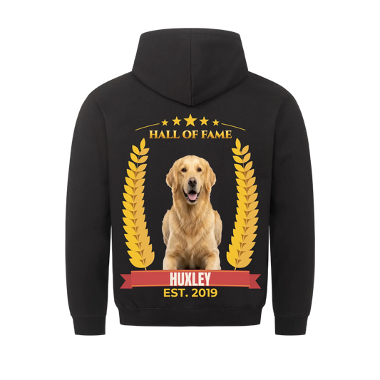 Black hoodie back print: golden retriever photo between gold laurel branches, HALL OF FAME in gold under five stars, name HUXLEY on a crimson winner's ribbon, EST. 2019