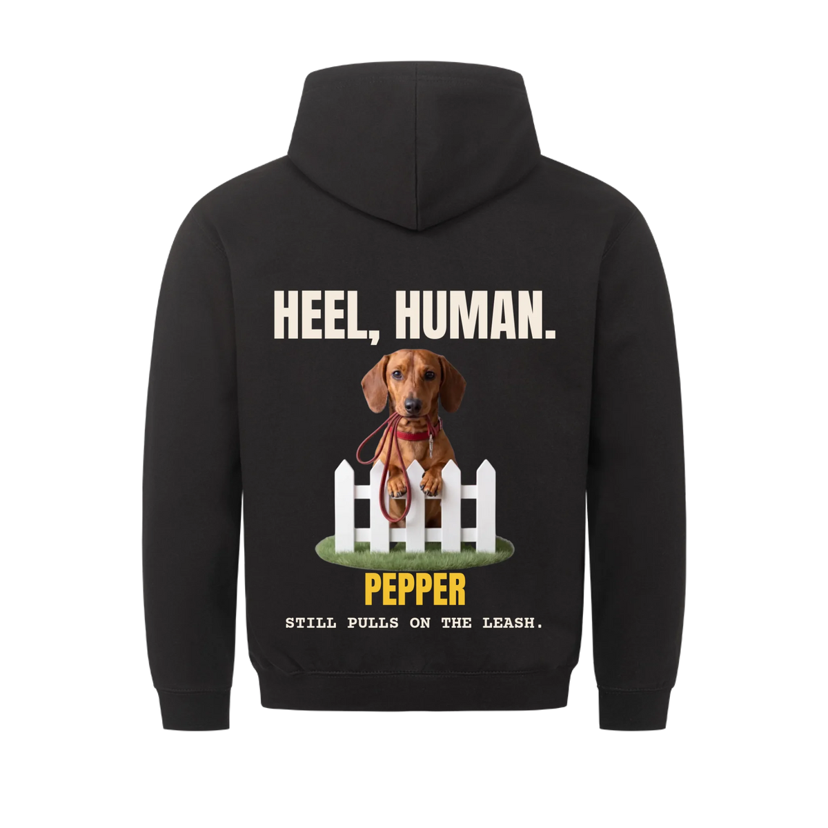 Heel, Human custom pet hoodie black, back print - your dog behind a picket fence with a red leash in its mouth, with name